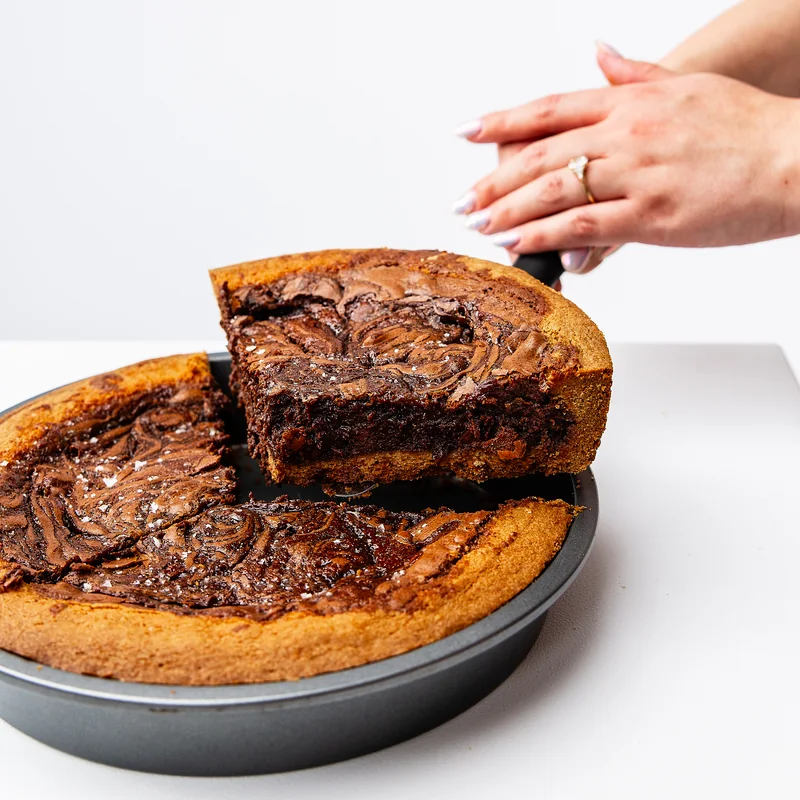 Chocolate brownie and salted caramel pie in a chocolate-chip cookie crust